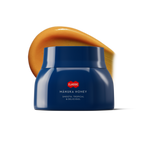 Blue jar of Manuka honey with honey swatch behind it.