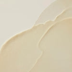 Close-up of a beige ceramic plate with scalloped edge on a light background
