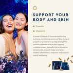 Promotional graphic for a skincare product. The left side features two smiling women embracing against a dark blue floral background.