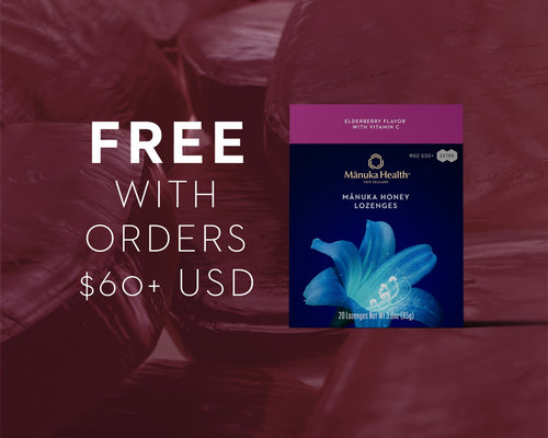 Manuka Health lozenge packaging with promotional text on a blurred background