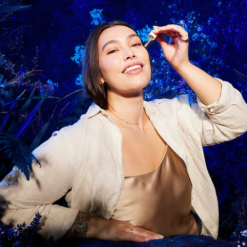 Woman Eternal Renewal Eye Serum against a blue floral background.